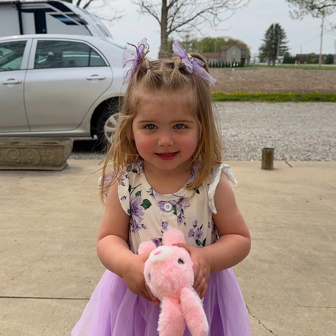 Oakley is registered to the contest to win money with this photo: alloywheel, car, carwheel, child, clothing, dress, eveningdress, face, female, girl, head, machine, person, photography, portrait, spoke, tire, transportation, vehicle, wheel