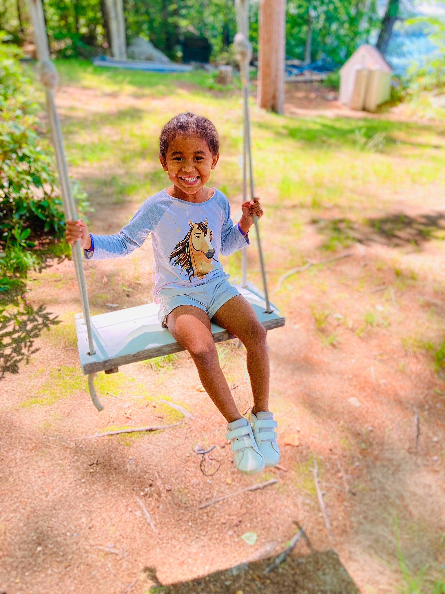 Aniya is registered to the contest to win money with this photo: baby, baby_toddler_clothing, city, grass, happy, joy, leisure, outdoor_play_equipment, people_in_nature, person, plant, playground, recreation, shorts, sitting, smile, soil, summer, swing, toddler