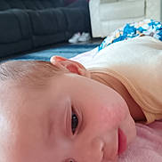 Sarah joined the competition — help win amazing prizes! baby, infant, child, face, eyes, lying_down, indoors, blanket, pink_blanket, living_room, sofa, armchair, clothing, portrait, close_up, looking_at_camera, awake, skin, head, cozy