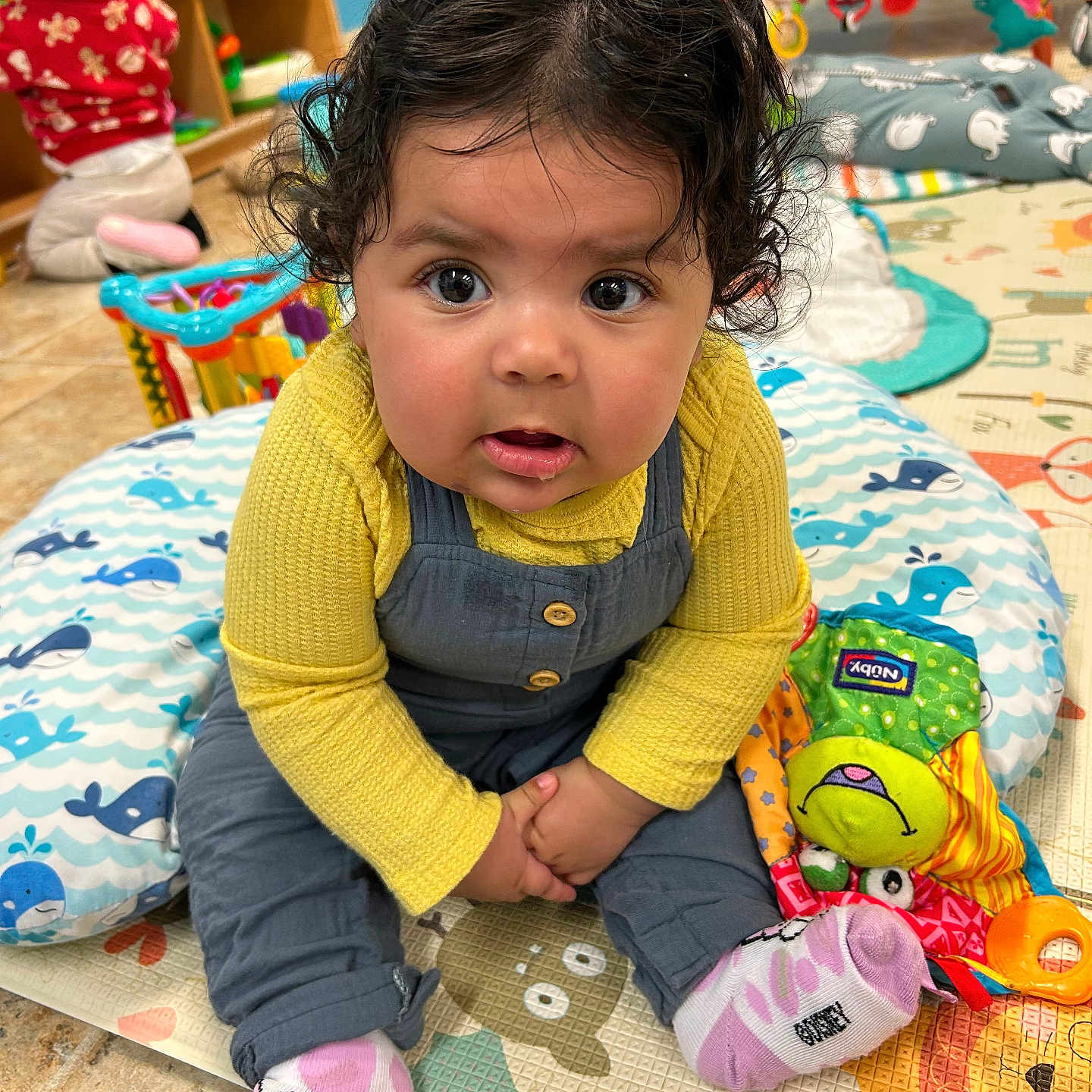 Gianna joined the competition — help win amazing prizes! baby, clothing, couch, cushion, face, footwear, furniture, head, homedecor, hosiery, indoors, interiordesign, pants, person, photography, portrait, shoe, sitting, sock, toy