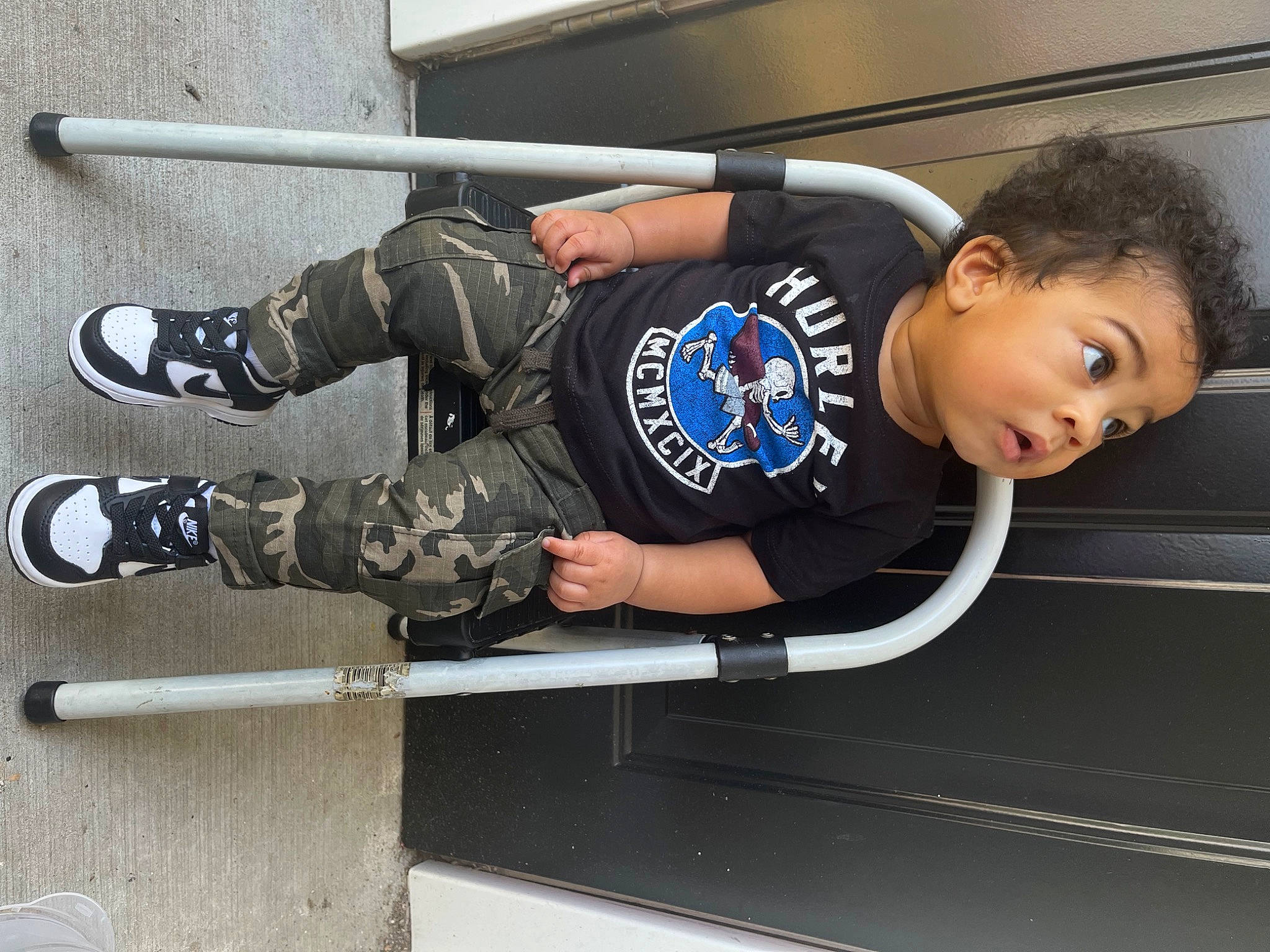 Kaycen is registered to the contest to win money with this photo: arm, elbow, fun, helmet, knee, outdoor_shoe, person, personal_protective_equipment, recreation, roller_sport, rolling, sitting, sleeve, sneakers, sports, sports_equipment, sports_gear, sportswear, surprise, t_shirt