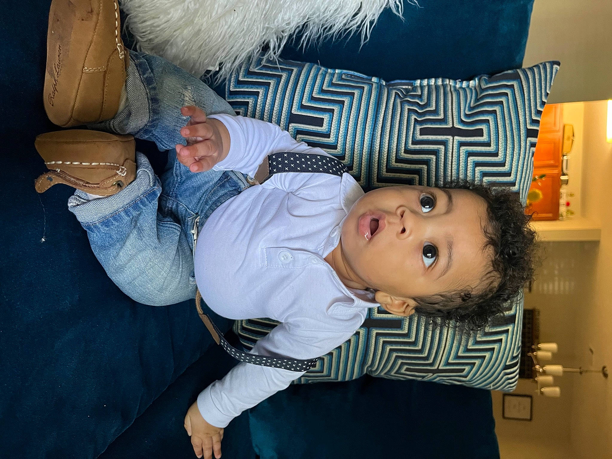 Kaycen joined the competition — help win amazing prizes! baby_products, baby_toddler_clothing, child, comfort, couch, elbow, fun, gesture, happy, human_leg, knee, linens, mammal, mouth, person, pillow, room, sitting, surprise, textile