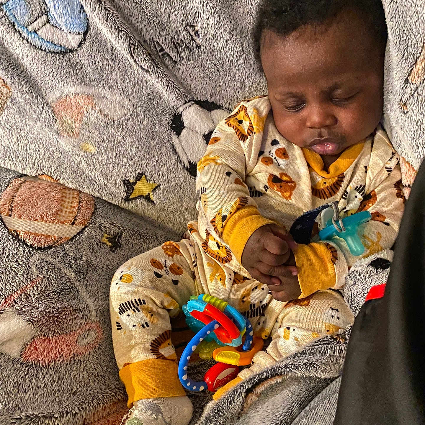 Kaizen is registered to the contest to win money with this photo: baby, sleeping, pajamas, blanket, toy, infant, child, cozy, cute, patterned, animal_print, resting, hands, footwear, indoor, portrait, peaceful, soft, comfort, nap