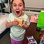 child, surprised, cake_box, snacks, table, bedroom, bed, pajamas, shorts, tshirt, face, expression, indoor, carpet, window, curtains, water_bottle, remote_control, green_bag, food