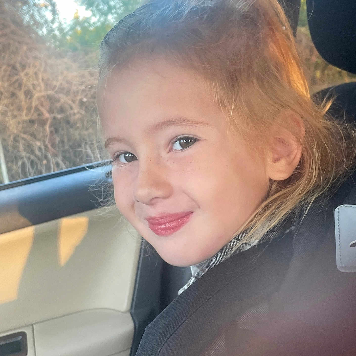 Madelyn is registered to the contest to win money with this photo: accessories, child, clothing, coat, cosmetics, cushion, face, female, girl, happy, head, homedecor, jacket, lipstick, person, photography, portrait, smile, transportation, vehicle