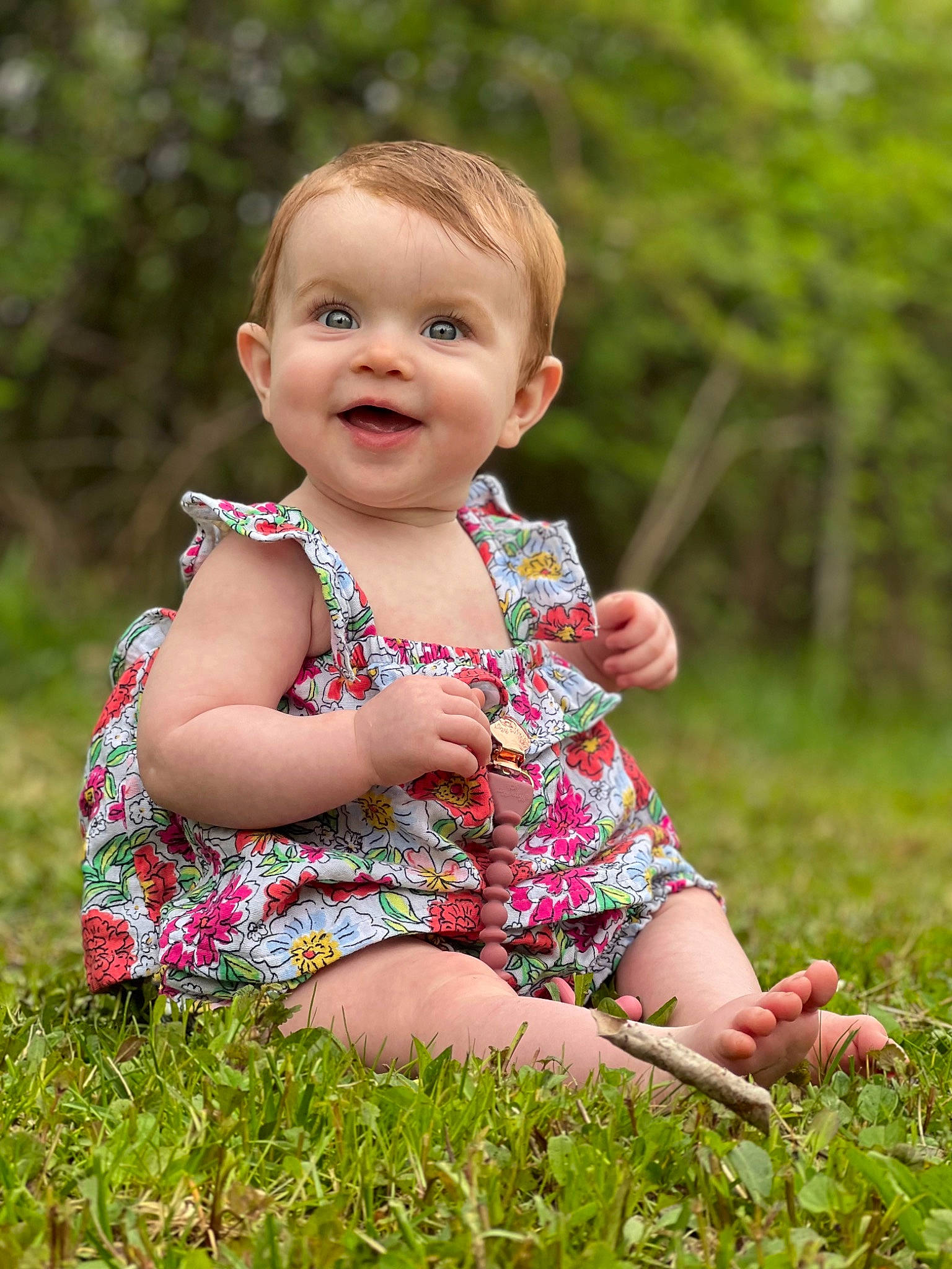 Ensley joined the competition — help win amazing prizes! baby, baby_laughing, baby_toddler_clothing, blond, child, dress, face, fun, grass, happy, joy, leaf, pattern, people_in_nature, person, pink, plant, sitting, smile, spring