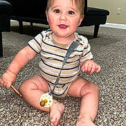Nehemiah joined the competition — help win amazing prizes! baby, smiling, striped_onesie, pacifier, carpet, sitting, indoor, child, furniture, wall, floor, happy, person, cute, infant, playful, head, hand, foot, toy