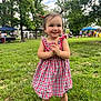toddler, child, smile, dress, pigtails, grass, park, outdoor, people, trees, sunlight, happy, footwear, summer, nature, playful, event, greenery, young_child, daylight
