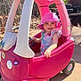 Ravynn is registered to the contest to win money with this photo: toddler, child, pink, toy_car, hat, smiling, outdoor, sunny, dog, concrete, shoes, play, vehicle, fence, flowers, person, happy, cute, summer, plastic