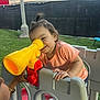 Ravynn joined the competition — help win amazing prizes! toddler, child, toy, telescope, playground, outdoor, grass, plastic, play_structure, happy, smile, casual_clothing, short_sleeves, footwear, person, daylight, fun, friendship, curly_hair, interaction