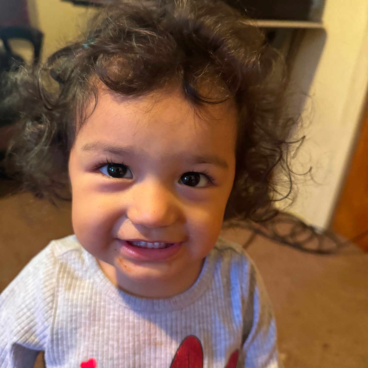 Analei is registered to the contest to win money with this photo: carpet, casual, child, closeup, clothing, curly_hair, cute, face, happy, home, indoor, minnie_mouse, person, portrait, red_hearts, smiling, sweater, toddler, warm_light, young_child