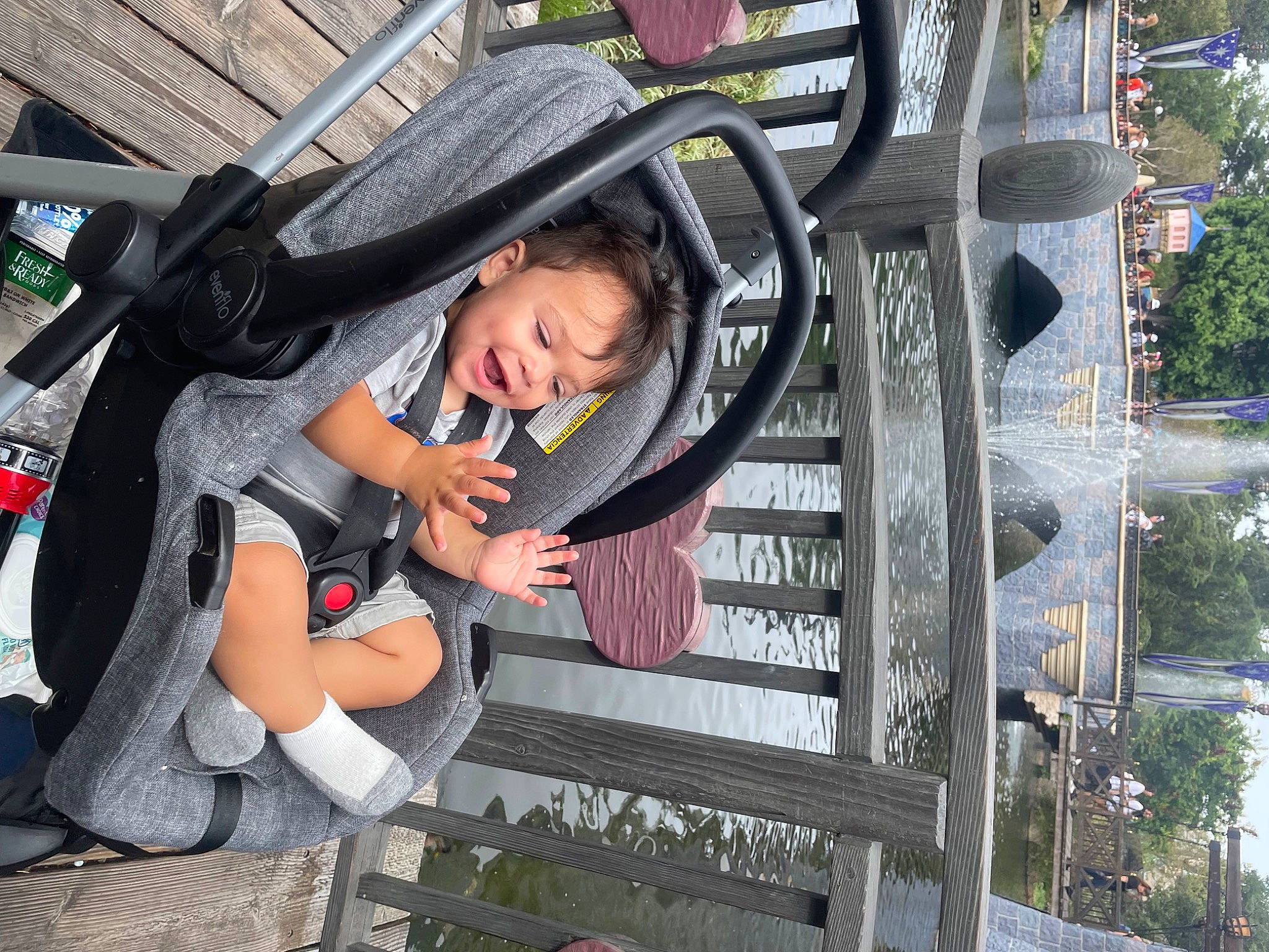 Eddie is registered to the contest to win money with this photo: baby, baby_carriage, baby_products, child, city, costume, fun, hat, human_leg, leisure, luggage_and_bags, person, plant, recreation, sun_hat, thigh, toddler, tourism, travel, tree