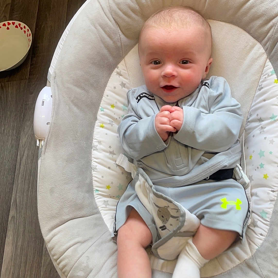 Denver is registered to the contest to win money with this photo: baby, bed, clothing, couch, crib, cushion, cutlery, face, furniture, head, homedecor, hosiery, infantbed, newborn, pants, person, photography, portrait, sock, spoon