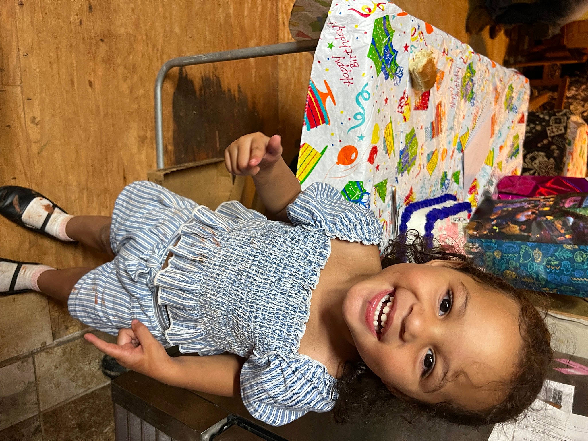 Riley is registered to the contest to win money with this photo: art, chair, child, couch, foot, fun, happy, human_leg, joy, leisure, pattern, people, person, room, sitting, smile, t_shirt, textile, thigh, toddler
