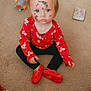 toddler, child, face_paint, red_shoes, red_shirt, carpet, toy, book, plaid_blanket, indoor, sitting, cute, portrait, playful, freckled_face, blue_eyes, casual_clothing, floor, young_child, looking_up