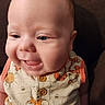 baby, button, cartoon, child, closeup, clothing, cute, face, happy, indoor, infant, orange, person, portrait, sitting, smile, tongue, winnie_the_pooh, yellow, young