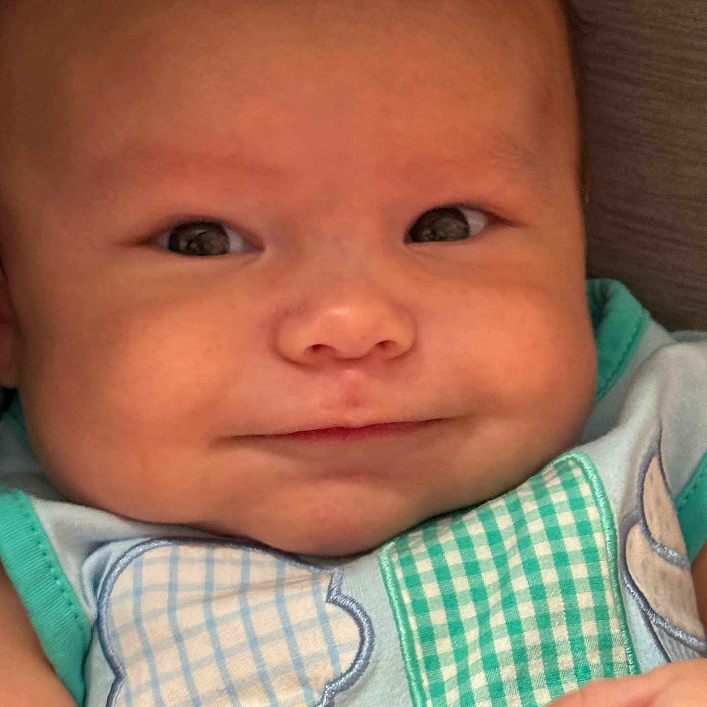 Griffin is registered to the contest to win money with this photo: apparel, baby, child, chubby_cheeks, closeup, clothing, cute, expression, eyes, fabric, face, hand, ice_cream_patch, infant, newborn, pattern, person, portrait, skin, smile