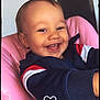 toddler, smiling, child, high_chair, pink, jacket, happy, face, indoor, young_child, cute, clothing, person, baby, portrait, cheerful, seat, infant, joy, casual