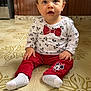 toddler, child, baby, sitting, floor, mickey_mouse, red_pants, white_shirt, bow_tie_print, curious, indoors, tile_floor, patterned_floor, cute, clothing, person, young_child, small_hands, expression, looking_up