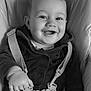 baby, child, smiling, high_chair, seatbelt, happy, face, hand, clothing, infant, portrait, monochrome, black_and_white, cute, young, person, baby_boy, seat, indoor, expression