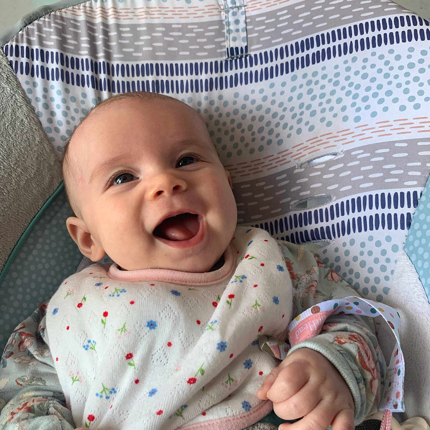 Annlee joined the competition — help win amazing prizes! baby, bib, child, closeup, clothing, comfort, cute, expression, fabric, hand, happy, indoor, infant, pattern, person, portrait, seat, sitting, smiling, young