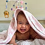 baby, blanket, smiling, infant, cute, face, child, soft_texture, nursery, toy_mobile, pink, happy, lying_down, indoors, playful, skin, expression, closeup, cozy, toddler