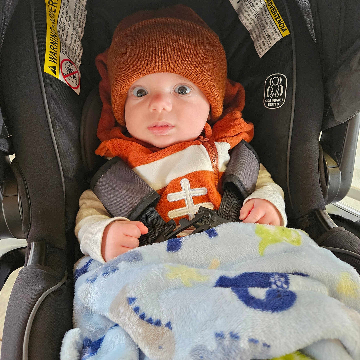 Lincoln is registered to the contest to win money with this photo: baby, bonnet, cap, car, car_interior, carseat, clothing, coat, cushion, face, glove, hat, head, homedecor, jacket, person, photography, portrait, transportation, vehicle
