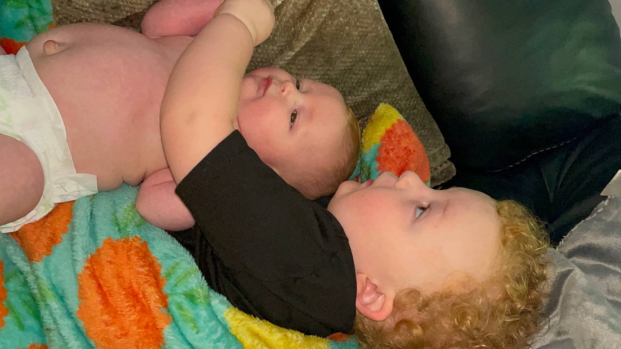 Russell is registered to the contest to win money with this photo: abdomen, baby, baby_toddler_clothing, bedtime, cheek, child, comfort, eyelash, grass, happy, linens, orange, pattern, person, room, skin, sleep, textile, toddler, wood