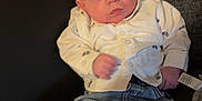 Lincon joined the competition — help win amazing prizes! baby, infant, child, couch, clothing, jeans, shirt, sneakers, footwear, indoor, person, face, head, expression, cute, young, seated, blanket, home, casual