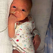 Lincon joined the competition — help win amazing prizes! newborn, baby, infant, hospital, wristband, feeding_tube, blanket, clothing, star_pattern, bear_pattern, lying_down, soft_lighting, cute, small_hand, small_foot, bed, medical_equipment, curious_expression, indoors, portrait