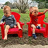 Uriah Luca is registered to the contest to win money with this photo: toddler, child, red_chair, outdoor, grass, barefoot, sock, casual_clothing, playful, waving, curious, suburban, tree, lawn, daytime, two_children, cute, happy, nature, portrait