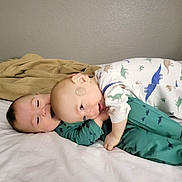 Uriah Luca joined the competition — help win amazing prizes! baby, babies, bed, blanket, child, cuddle, dinosaur_pajamas, family, fun, happy, infant, indoors, laying_down, love, one_piece_pajamas, playful, pajamas, sibling, smiling, toddler