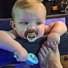 baby, child, infant, pacifier, toy, playpen, indoor, portrait, face, hands, foot, adult, family, curious, sitting, leaning, blond_hair, blue_eyes, colorful, home