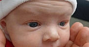 Asher is registered to the contest to win money with this photo: baby, blue_eyes, christmas, closeup, costume, cute, expression, face, festive, hand, holiday, indoors, infant, newborn, person, santa_hat, skin, soft, tiny, wrinkles