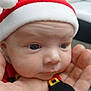 Asher is registered to the contest to win money with this photo: baby, infant, face, hand, santa_hat, christmas, holiday, costume, blue_eyes, wrinkles, cute, closeup, skin, person, newborn, expression, tiny, festive, soft, indoors
