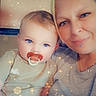 baby, infant, adult, woman, mother, portrait, selfie, smiling, cuddling, pacifier, blue_eyes, indoor, close_up, sparkles, photo_filter, gray_clothing, white_clothing, family, sitting, happy