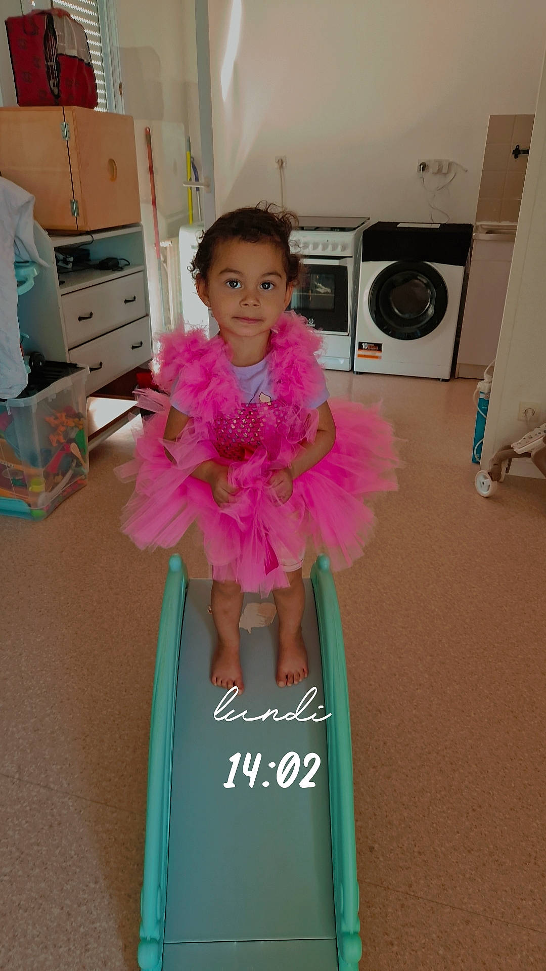 Sinaya participe au concours pour gagner de l'argent avec cette photo : baby_toddler_clothing, cabinetry, child, clothes_dryer, drawer, dress, event, fashion_design, flooring, fun, happy, home_appliance, laundry_room, magenta, person, pink, smile, standing, textile, toddler