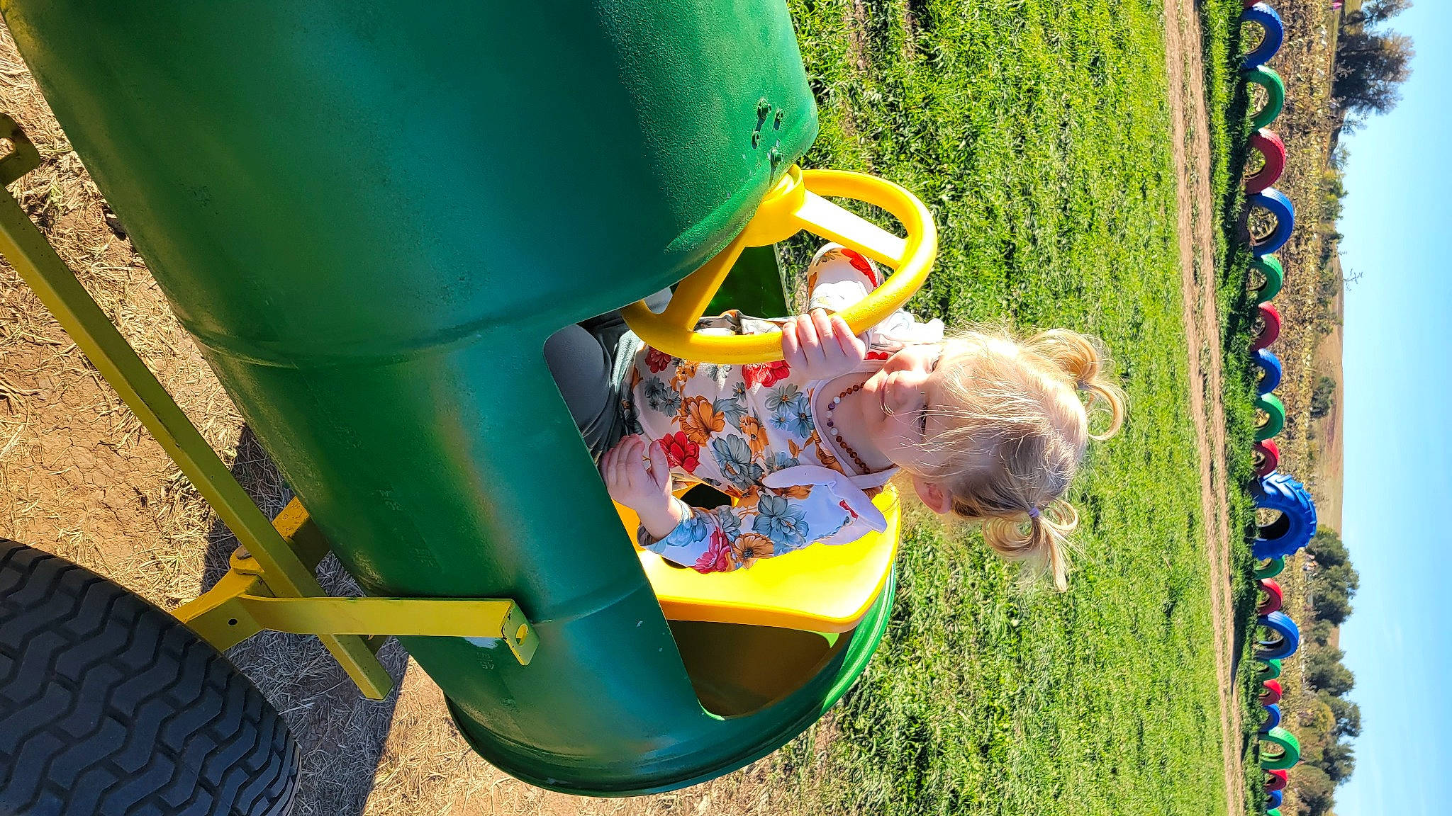 Emberly is registered to the contest to win money with this photo: baby_toddler_clothing, child, chute, city, fun, grass, green, joy, leisure, outdoor_play_equipment, people_in_nature, person, plant, play, playground, recreation, soil, toddler, yard, yellow