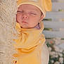 adorable, baby, blanket, child, cozy, cute, face, floral_background, hat, indoors, infant, newborn, peaceful, portrait, resting, sleeping, soft_lighting, soft_texture, warm_colors, yellow_outfit