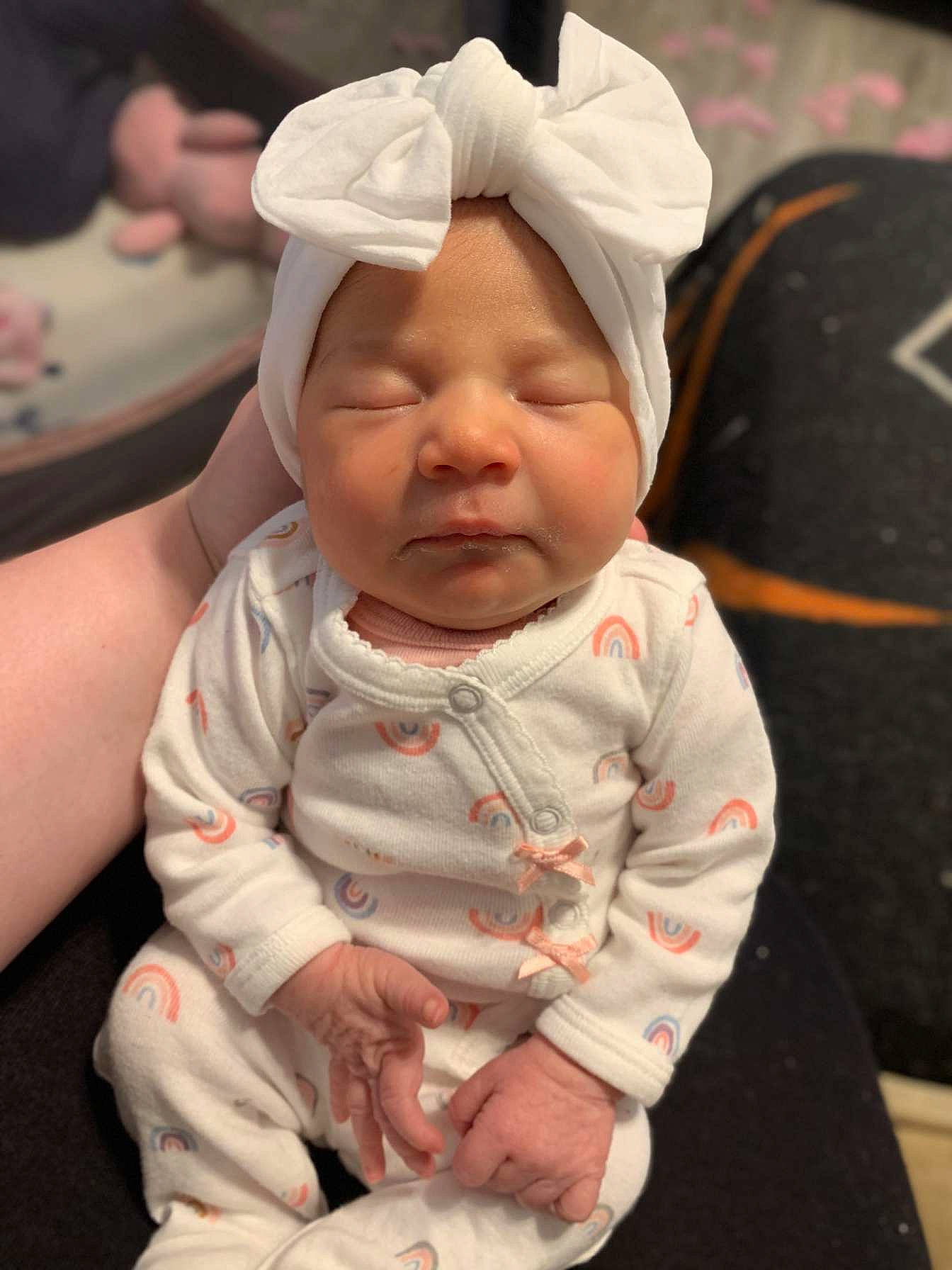 Addison is registered to the contest to win money with this photo: baby, baby_toddler_clothing, cheek, child, chin, comfort, eye, fun, happy, headwear, iris, lip, mouth, person, pink, sitting, skin, sleeve, smile, textile