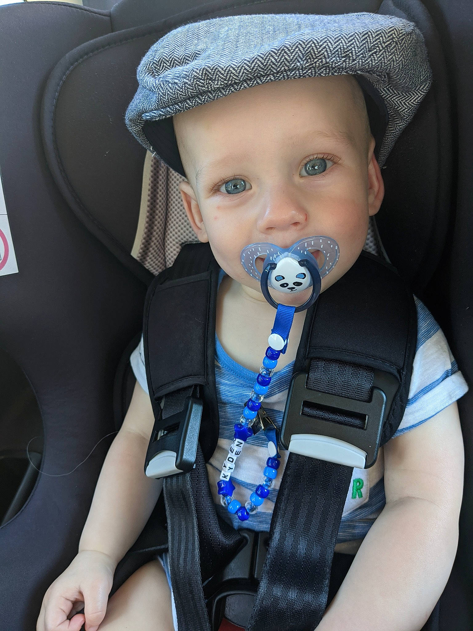 Kyden is registered to the contest to win money with this photo: auto_part, baby, baby_carriage, baby_products, baby_toddler_clothing, car_seat, car_seat_cover, cool, electric_blue, fashion_accessory, hat, head_restraint, headwear, iris, light, nail, person, seat_belt, steering_part, steering_wheel