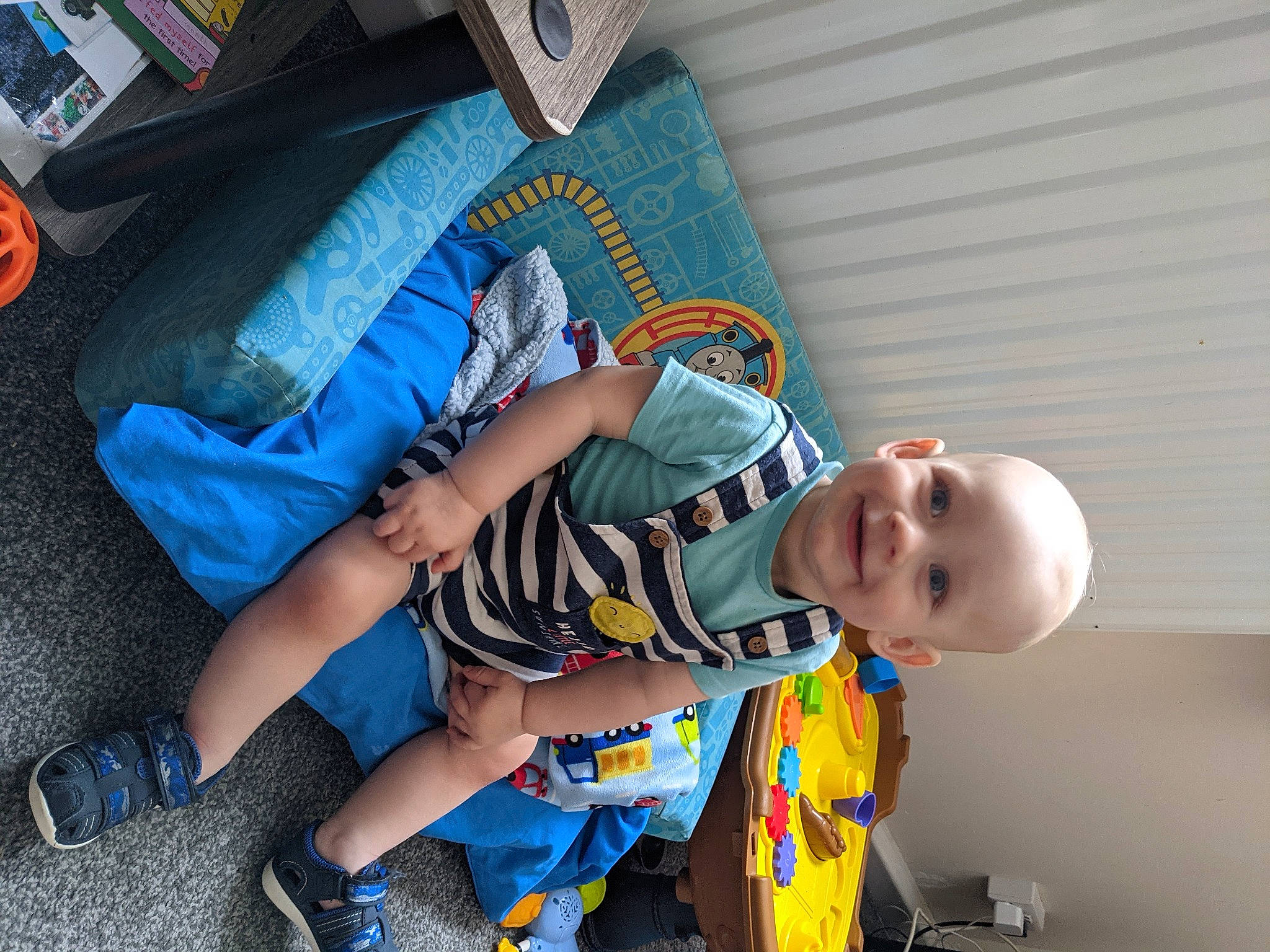 Kyden is registered to the contest to win money with this photo: baby, baby_products, baby_toddler_clothing, carmine, child, comfort, electric_blue, fun, happy, human_leg, joint, joy, lap, leg, pattern, person, sitting, smile, sock, sunglasses