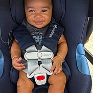 Jy Len is registered to the contest to win money with this photo: baby, child, smiling, car_seat, safety_harness, blue, clothing, infant, cute, person, seat, straps, happy, indoors, toddler, sitting, face, hands, legs, footwear