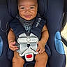 baby, child, smiling, car_seat, safety_harness, blue, clothing, infant, cute, person, seat, straps, happy, indoors, toddler, sitting, face, hands, legs, footwear