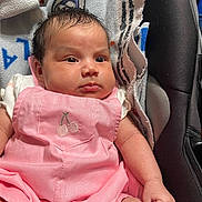 Athena joined the competition — help win amazing prizes! baby, infant, pink_outfit, cherry_embroidery, car_seat, towel, face, skin, arm, clothing, indoor, child, cute, newborn, portrait, seatbelt, fabric, comfort, expression, person