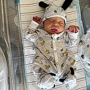 Teghan is registered to the contest to win money with this photo: baby, baby_clothes, bassinet, bed, blanket, child, cute, hat, hospital, indoors, infant, newborn, onesie, pacifier, peaceful, person, resting, sleep, sleeping, soft