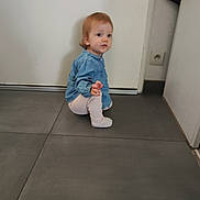Abby a rejoint le concours — aidez-le/la à gagner de superbes lots ! baby, candid, casual_clothing, child, curious, denim_shirt, door, floor_tile, footwear, hair, indoor, light_pants, long_sleeve, person, plug_socket, squatting, tiled_floor, toddler, wall, young_child