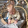 Vladimir a rejoint le concours — aidez-le/la à gagner de superbes lots ! chair, child, clothing, curious, cushion, face, footwear, hands, happy, indoor, interior, person, playful, rattan, shoe, sitting, smiling, sunlight, toddler, young_child