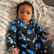 Zyire joined the competition — help win amazing prizes! baby, child, infant, onesie, clothing, stars, clouds, moon, blue, yellow, blanket, elephant_pattern, fabric, indoor, portrait, face, expression, curly_hair, sitting, person