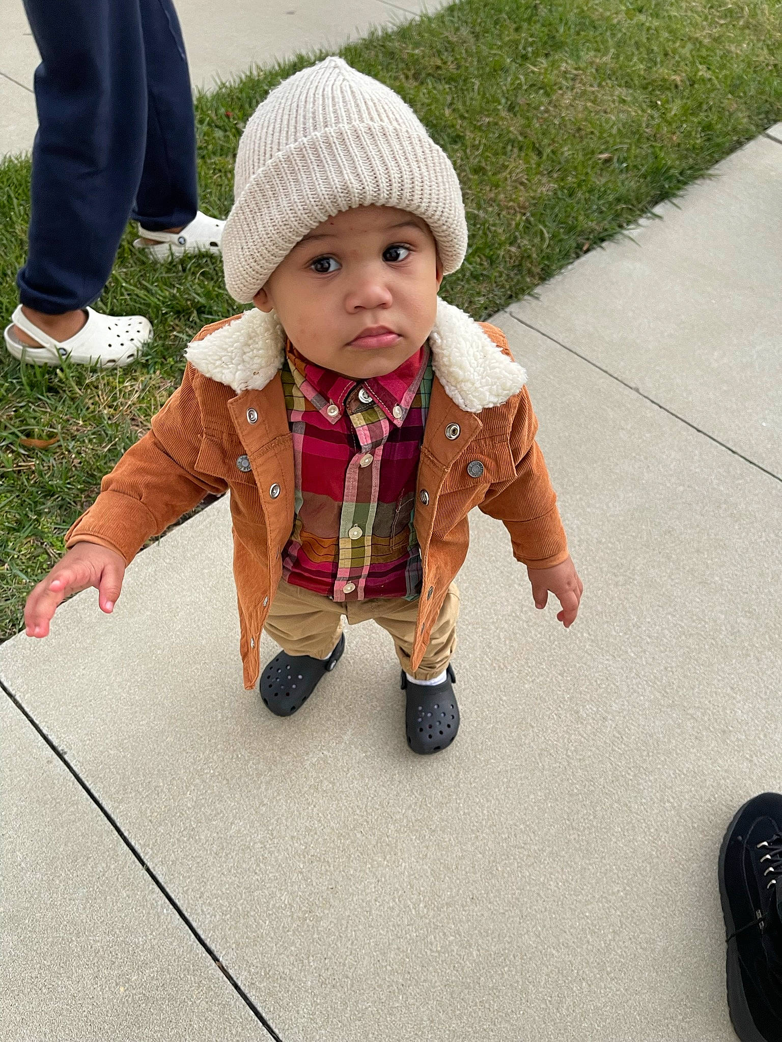Kaison joined the competition — help win amazing prizes! baby, baby_toddler_clothing, cap, child, clothing, face, fashion_accessory, flooring, grass, headwear, jacket, knit_cap, leg, pattern, people_in_nature, person, plant, road_surface, shoe, sidewalk